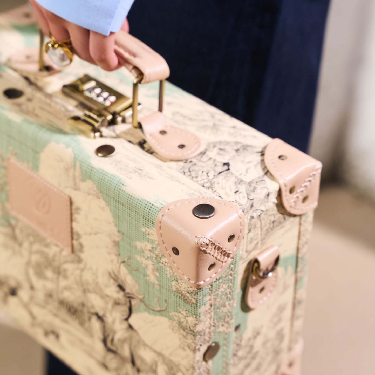compact hard shell luggage with vegan leather exterior finish detail