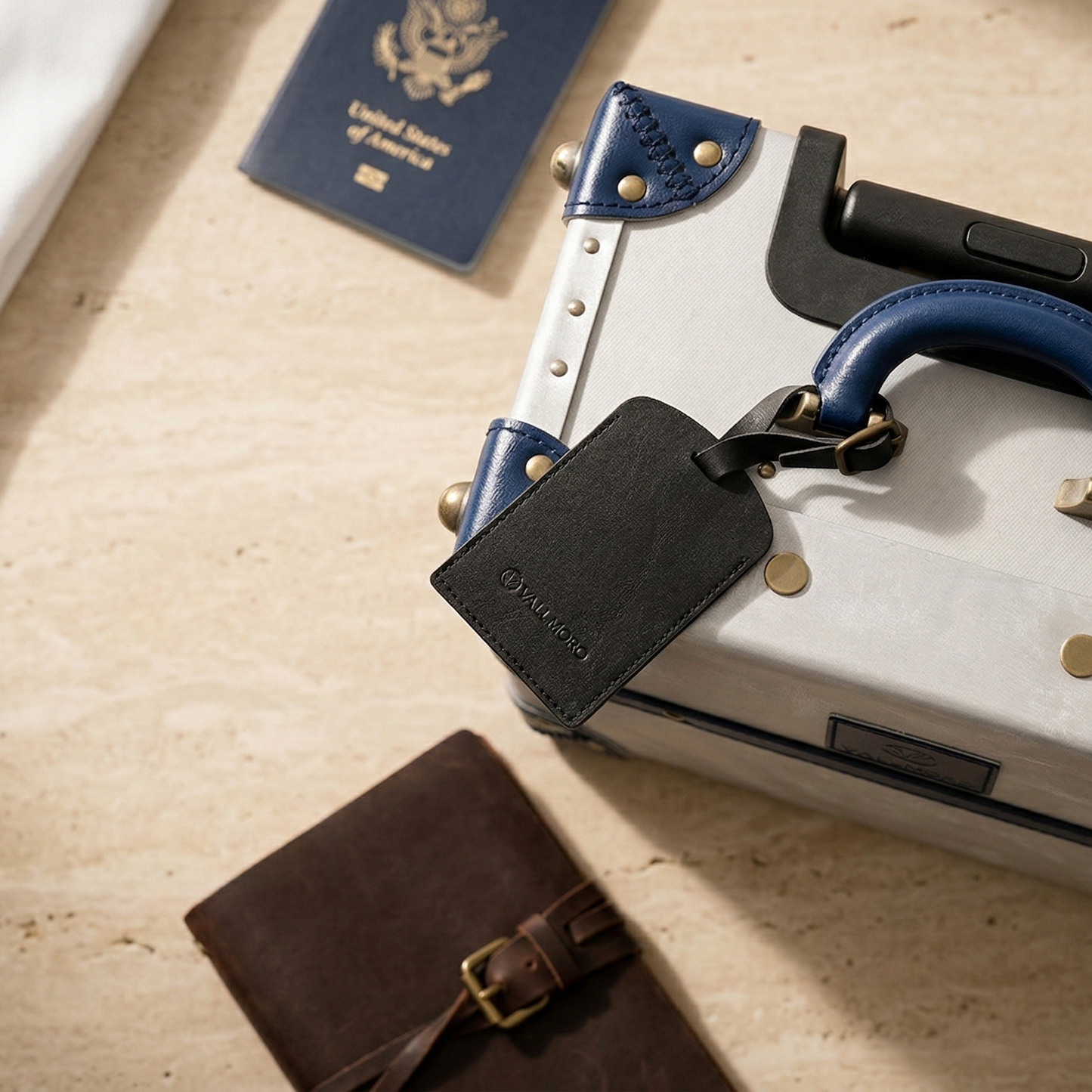 leather luggage tag attached to hard shell suitcase travel use