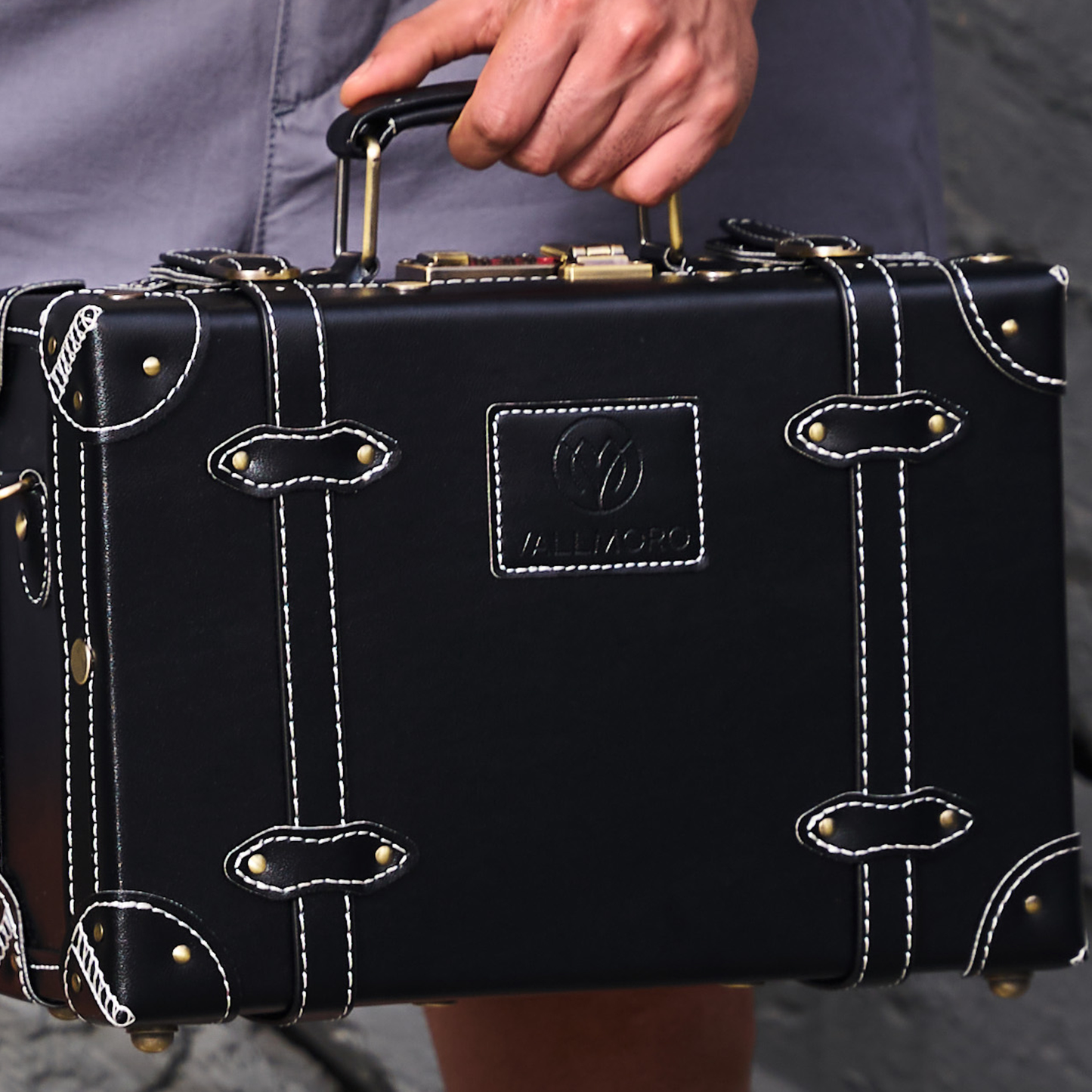compact hard shell luggage with vegan leather exterior finish detail