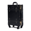 Black suitcase with gold accents on a white background , its a  20 inch carry on hard shell luggage side view durable structured build